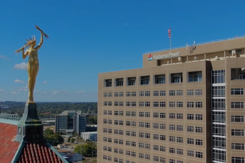 A building saying Alabama Power with the statue of a Greek god in the foreground