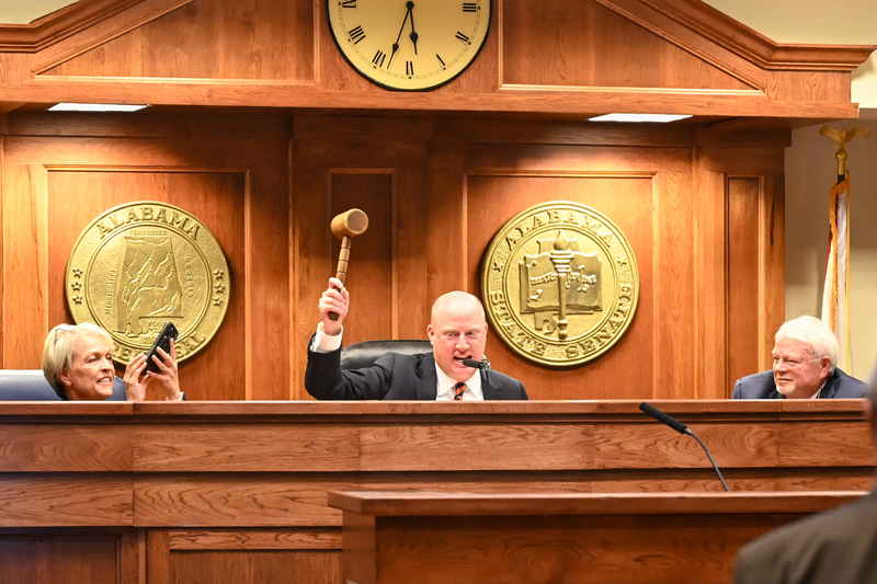 A man swinging a gavel