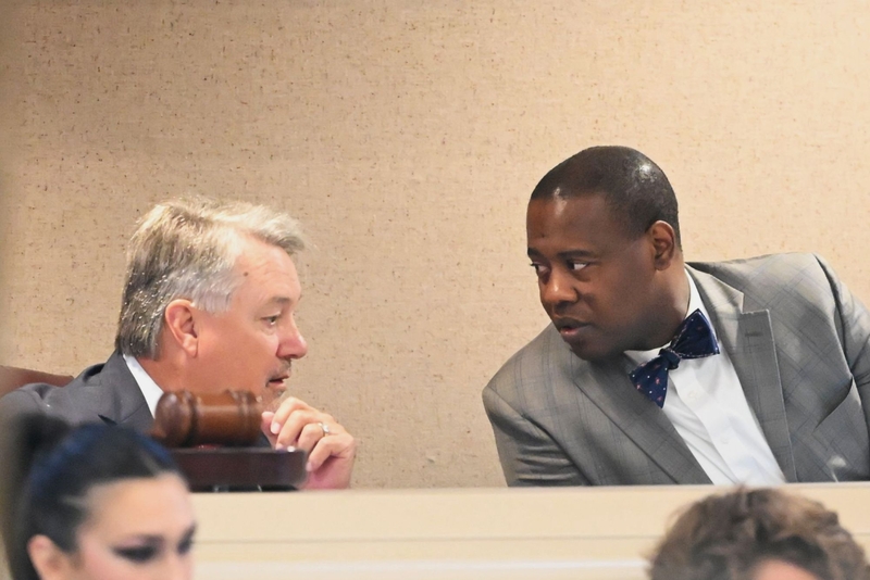 Two men in suits speaking