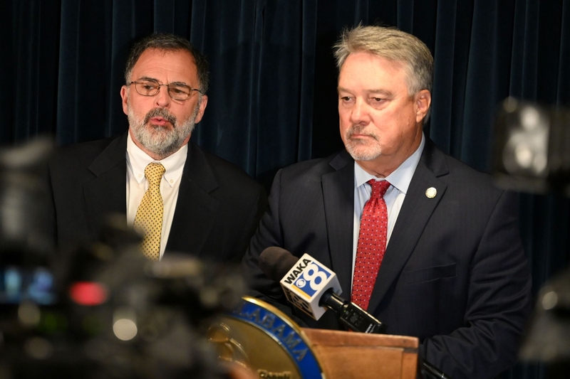 Two men in suits speaking