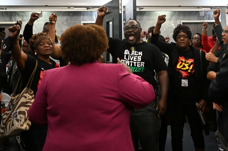 A group of people holding their fists up