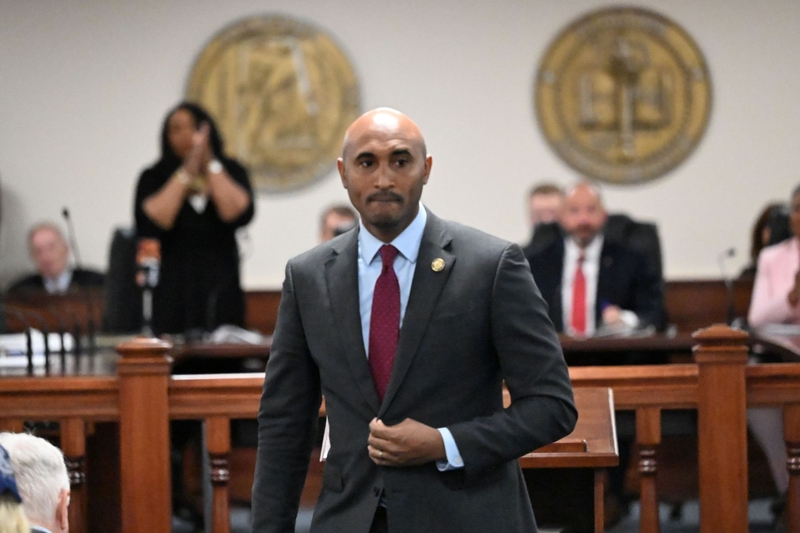 A man in a suit walking back