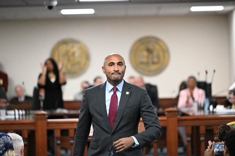 A man in a suit walking back