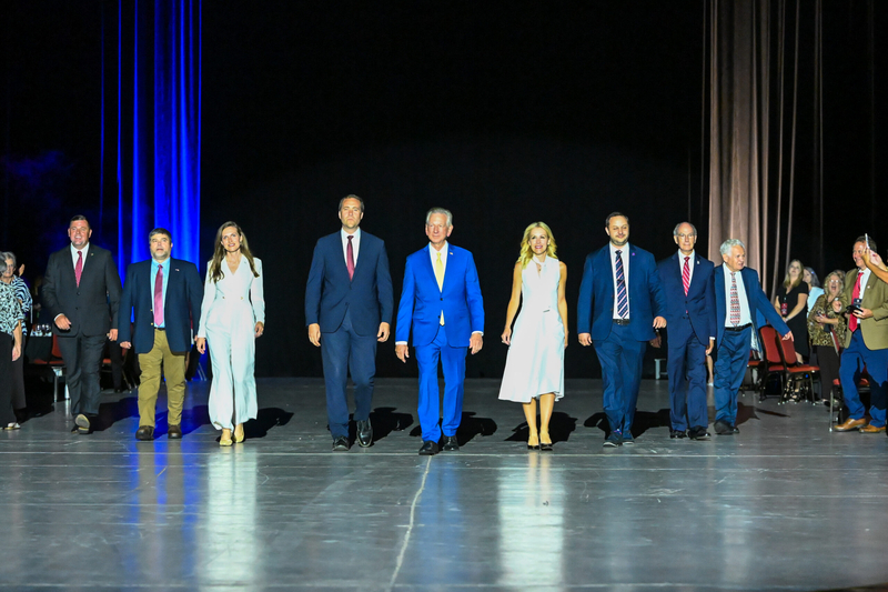 A group of men and women in suits walking together.