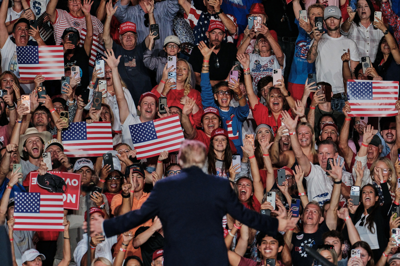 A man in a suit facing a crowd