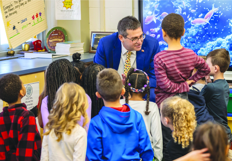 Matt Meyer talks with elementary school children during a school visit.