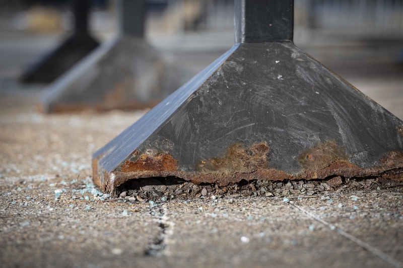 A rusty metal column with a broken bottom.
