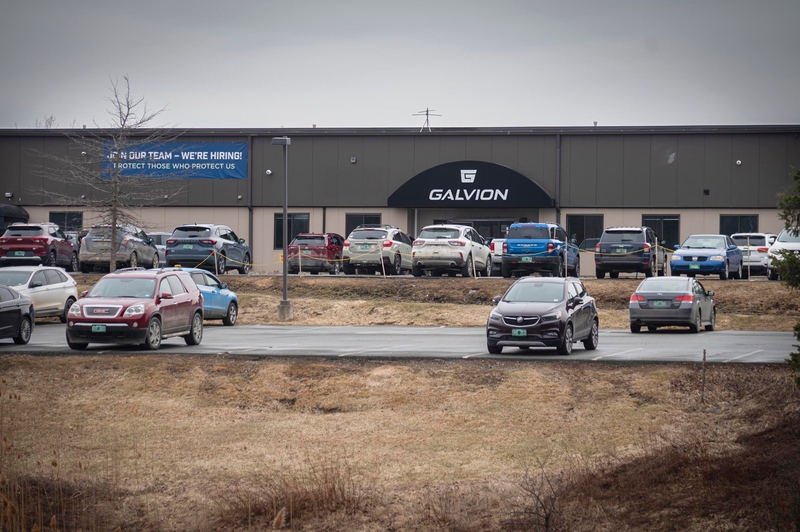 A parking lot with several cars in front of a building labeled "Galvion." A banner reads "Join Our Team—We're Hiring!.