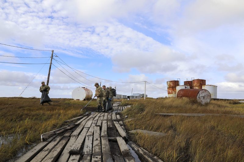 Alaska National Guardsmen in Newtok on Sept. 22 clear storm debris left by Typhoon Merbok. The Guardsmen went to several communities that suffered flooding and damage from that storm. (Photo by 1st Lt. Balinda O'Neal/Alaska National Guard)