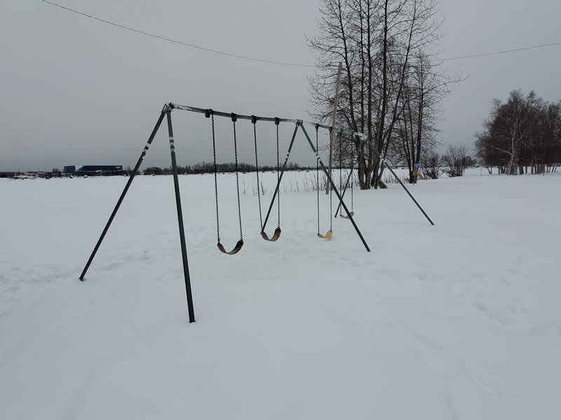 Snow covers children's play area at Anchorage's Spenard Beach Park. The park, seen on Thursday, is at the edge of Lake Spenard. The lake had levels of PFAS contamination more than 1,000 times the current federal standard for drinking-water safety, according to a study conducted by Alaska Community Action on Toxics. (Photo by Yereth Rosen/Alaska Beacon)