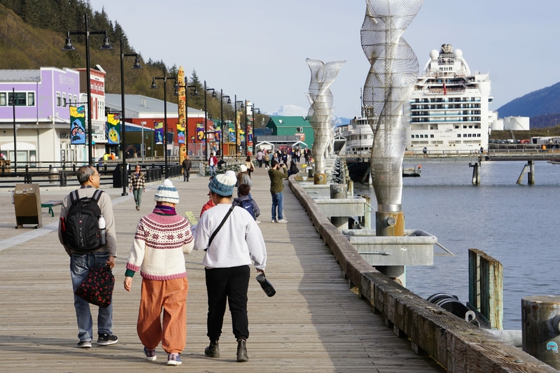 Cruise passengers stroll the waterfront in Juneau on May 9. Cruise visitiation in Alaska is expected to hit a new record this year, and that in turn is expected to send more visitors to Denali, where half the road remains closed because of landslide dangers. (Photo by Yereth Rosen/Alaska Beacon)
