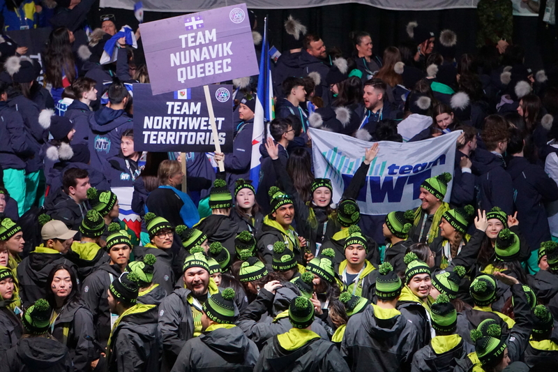 The delegation from Nunavik, the northern region of Quebec, files into Wasilla's Curtis D. Menard Memorial Sports Center next to Team Northwest Territories during the March 10 opening ceremonies for the 2024 Arctic Winter Games. (Photo by Yereth Rosen/Alaska Beacon)
