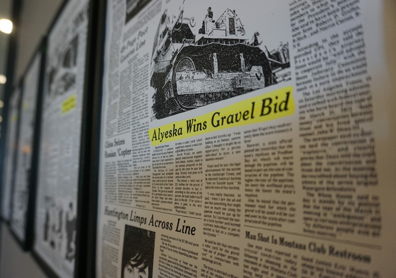 The copy of an Anchorage Time story about the construction of the North Slope Haul Road is displayed on a wall at the Petroleum Club of Anchorage on April 29 , 2024. (Photo by Yereth Rosen/Alaska Beacon)