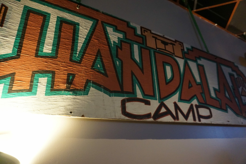 A sign for one of the work camps, rescued from a yard sale in Homer, is displayed on April 29, 2024, on the wall at the Petroleum Club of Anchorage as part of the exhibit marking the 50th anniversary of the Haul Road's construction. (Photo by Yereth Rosen/Alaska Beacon)