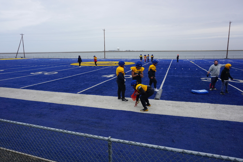 Members of the Barrow High School football team practice at the Utqiagvik field on Aug. 3, 2022. (Photo by Yereth Rosen/Alaska Beacon)