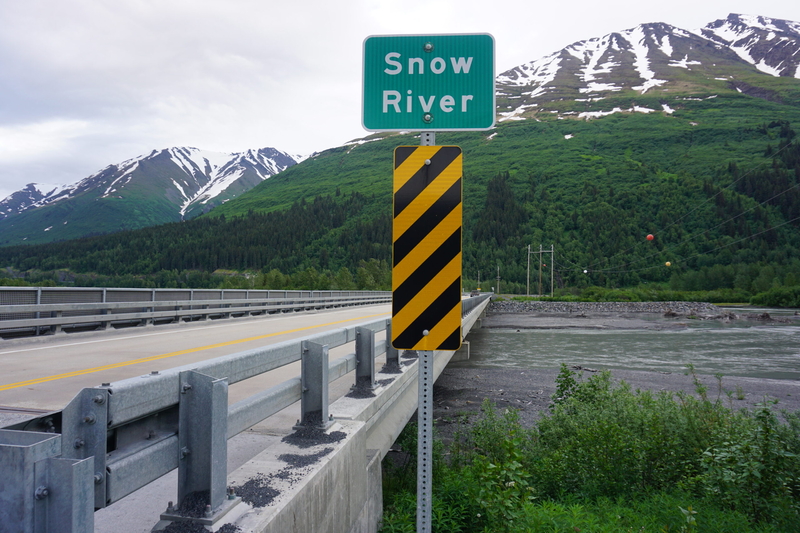 The glacier-fed Snow River, seen on June 21, 2025, flows under a highway bridge north of Seward. (Photo by Yereth Rosen/Alaska Beacon)