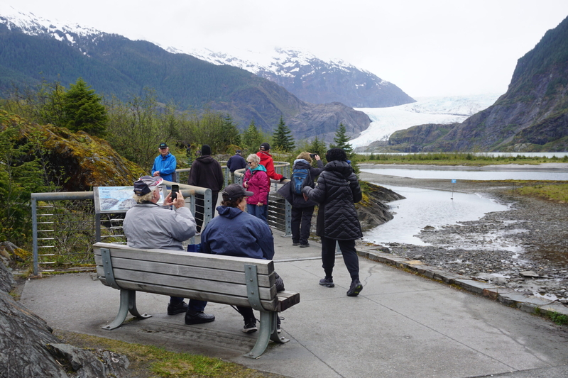Tourists take in the view at the Mendenhall Glacier visitor center on May 14, 2025. (Photo by Yereth Rosen/Alaska Beacon)
