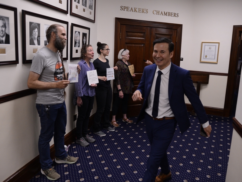 Rep. Neal Foster, D-Nome, walks past pro-override protesters before the start of a special legislative session on Saturday, Aug. 2, 2025, at the Alaska Capitol in Juneau. (Photo by James Brooks/Alaska Beacon)