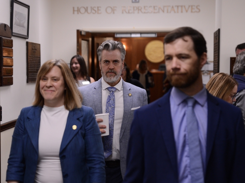 Rep. Andrew Gray, D-Anchorage (center) walks out of the House chambers at the start of a special legislative session on Saturday, Aug. 2, 2025, at the Alaska Capitol in Juneau. At left is House Minority Leader Mia Costello, R-Anchorage, and at right is Rep. Zack Fields, D-Anchorage. (Photo by James Brooks/Alaska Beacon)