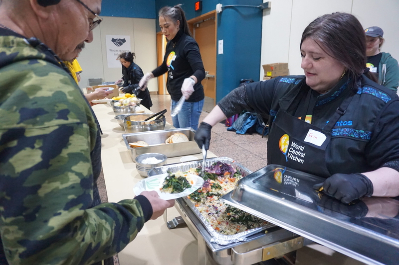 Erin Oliver of World Central Kitchen dishes oout salmon pilaf during lunch service on Oct. 29, 2025, at the William A. Egan Civic and Convention Center in Anchorage. The downtown center was serving as a temporary shelter and assistance hub for the hundreds of Yukon-Kuskokwim residents evacuated to Anchorage in the wake of Typhoon Halong. World Central Kitchen was one of the nonprofits responding to the disaster and helping to serve the displaced residents, almost all of whom are Yup'ik. The organization was