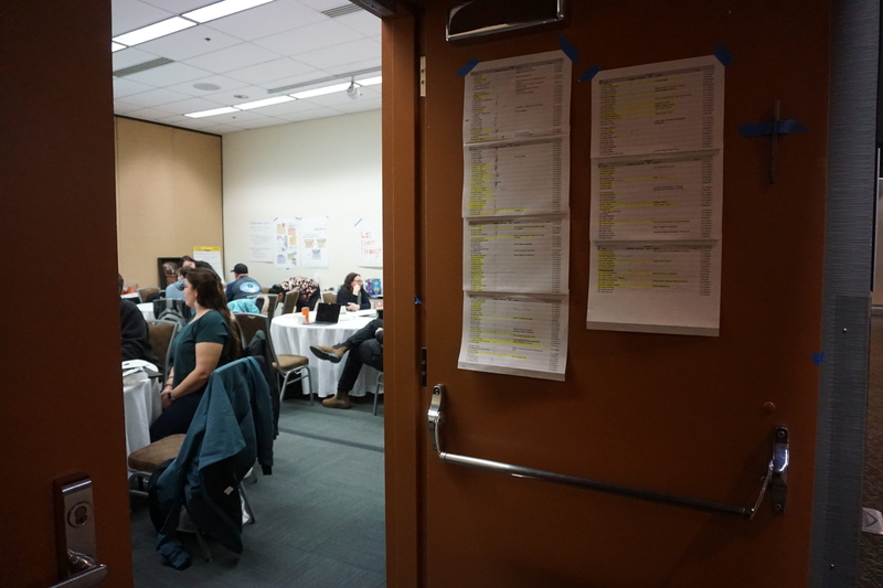 A list of people signed up to testify at the February meeting of the North Pacific Fishery Management Council is taped to an Egan Center room door on Feb. 9, 2026, The room, down the hall from the rooms where the council was convened, was reserved and used for the duration of the meeting by tribal oroganizations, including the Kuskokwim River Inter-Tribal Fish Commission and the Tanana Chiefs Conference. (Photo by Yereth Rosen/Alaska Beacon)
