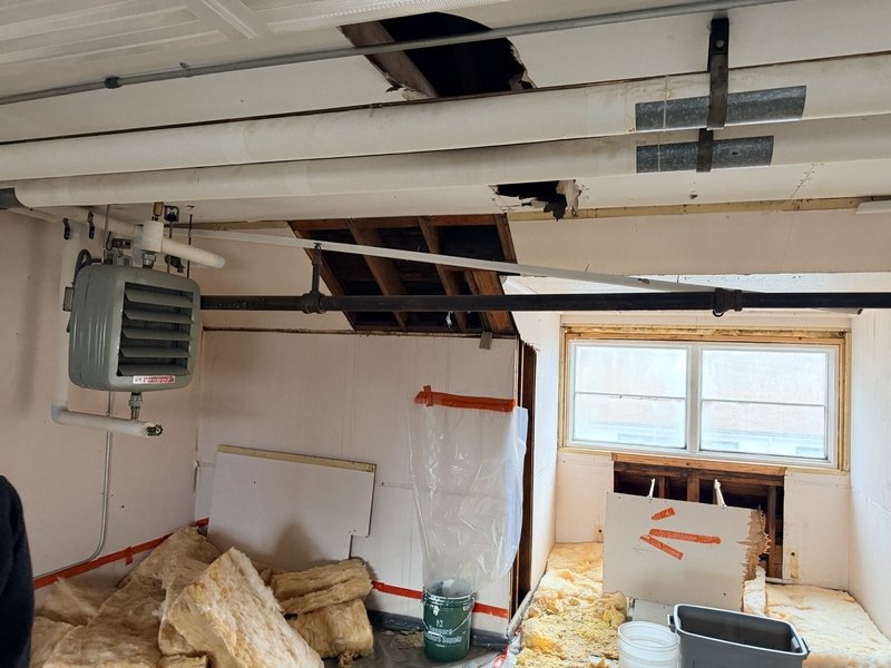 Buckets catch water from a leaky roof in the attic of a Mt. Edgecumbe High School dormitory, seen by legislators on a legislators' visit on Feb. 6, 2026. Photo courtesy of the Senate Finance Committee)