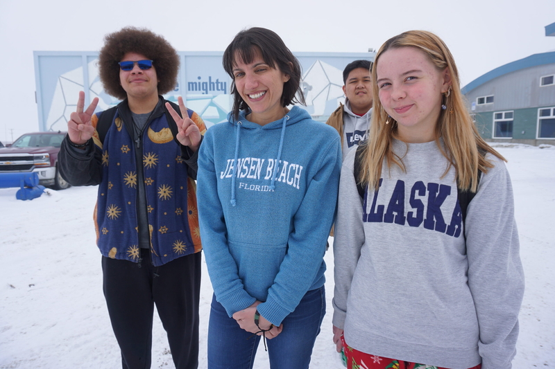Three of the Nome -Beltz High School students who took part in the study of algal toxins in local waters and fish, along with their teacher, stand outside the school on April 10, 2026. From left are Allen Yingling, science teacher Sarah Liben, Francis Luelle Papalid and Audrey Bruner-Alvanna. (Photo by Yereth Rosen/Alaska Beacon)