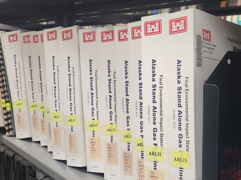 Gas pipeline records filing shelves in the Alaska Resources Library and Information Services, seen on June 8, 2026, inlude the multi-volume draft environmental impact statement and final environmental impact statement on the Alaska Stand Alone Gas Pipeline, known as ASAP. (Photo by Yereth Rosen/Alaska Beacon)
