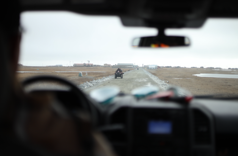 Four-wheelers drive down the road to Hooper Bay's airport. (Nathaniel Herz/Northern Journal)