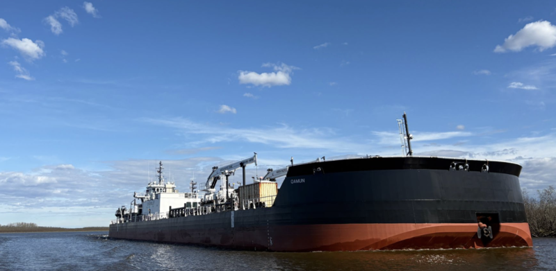 Crowley's Aurora tug pushes its companion barge, the Qamun, into the harbor in the Kuskokwim River hub town of Bethel on Tuesday, June 2. The Qamun can hold 55,000 barrels, or some 2.3 million gallons, of fuel. (Nathaniel Herz/Northern Journal)