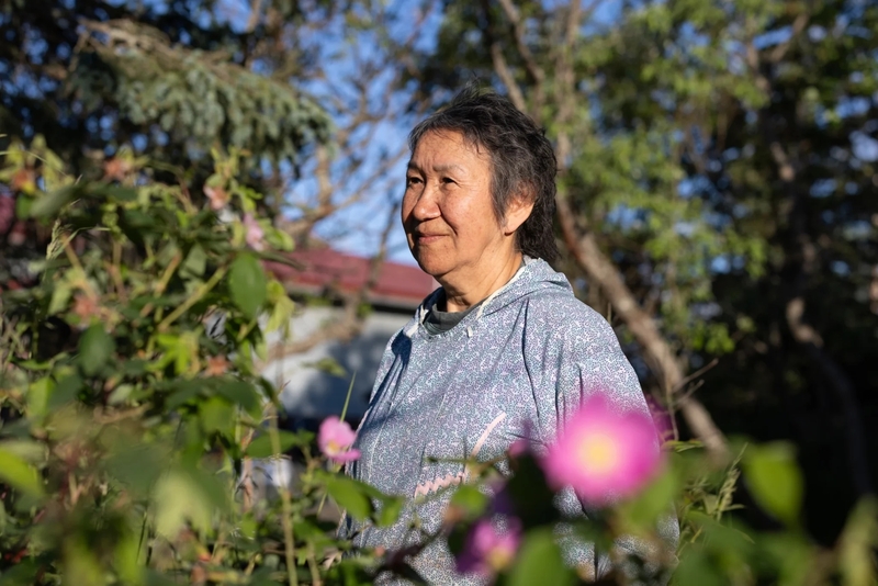 Rose Domnick stands outside her home in Bethel, Alaska, on July 6, 2026. (Katie Basile for Anchorage Press)