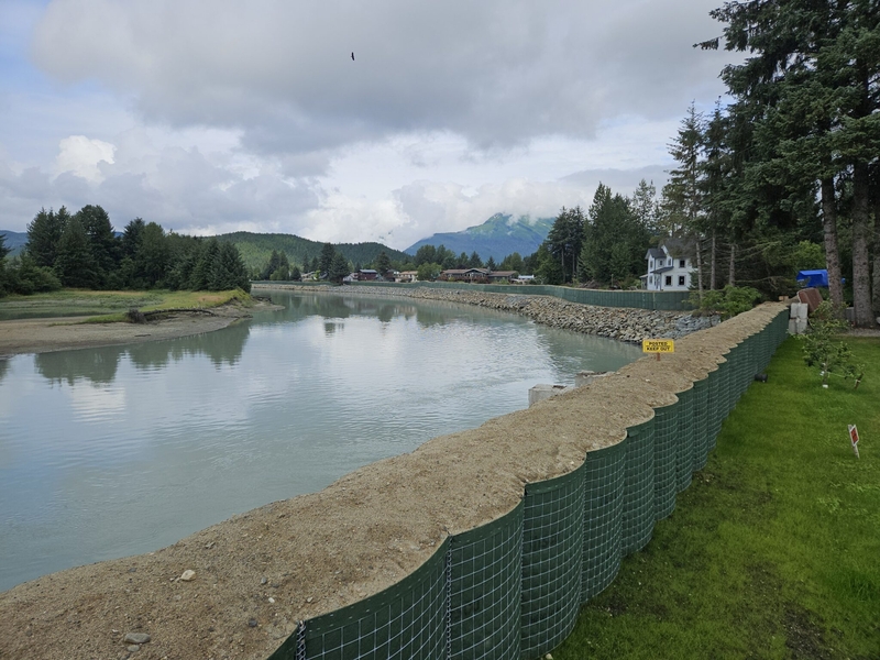 Sand bag barriers newly constructed this year in the lower part of the Mendenhall River below Brotherhood Bridge are seen from Meadow Lane in Juneau on Aug 8, 2026. (Photo by Corinne Smith/Alaska Beacon)