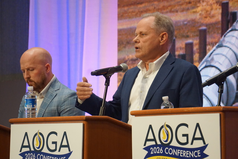 Former Anchorage Mayor Dave Bronson, a Republican who finished fourth in the open primary election, speaks at a gubernatorial candidate forum held on Aug. 26, 2026, by the Alaska Oil and Gas Association. Next to him is former state lawmaker Jonathan Kreiss-Tompkins, a Democratic candidate who received the most votes in the open primary. (Photo by Yereth Rosen/Alaska Beacon)