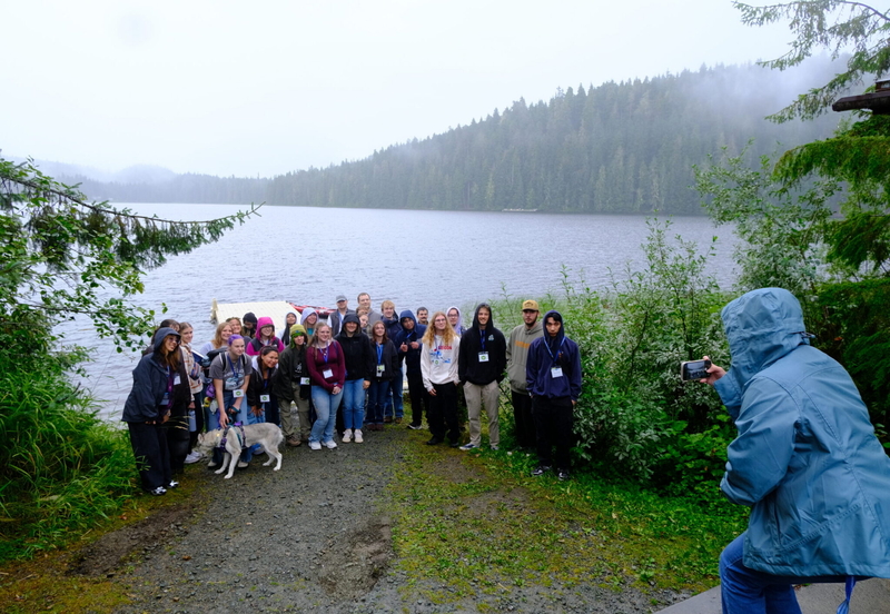 Southeast pose for a photo by Auke Lake during a campus tour as part of orientation on Aug. 21, 2026. (Photo by Corinne Smith/Alaska Beacon)