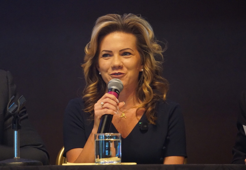 Anchorage business owner and talk-show host Bernadette Wilson, a Republican, speaks at a gubernatorial candidate forum held in Girdwood on Sept. 16, 2026, by the Alaska Hospital and Healthcare Association. (Photo by Yereth Rosen/Alaska Beacon)