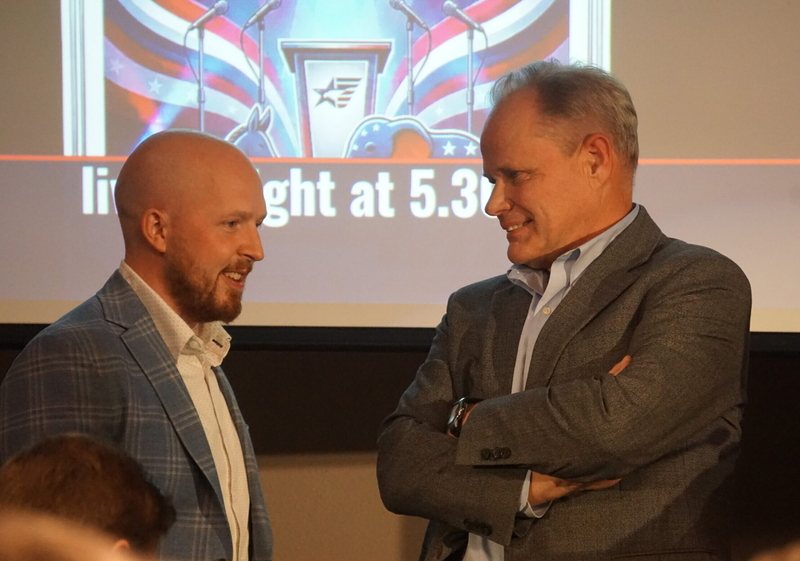 Former state Rep. Jonathan Kreiss-Tomkins, a Democrat, and former Anchorage Mayor Dave Bronson, a Republicanm chat before the start of a Sept. 8. 2026, gubernatorial candidate forum held by the Last Frontier Republican Club at the Petroleum Club of Anchorage. (Photo by Yereth Rosen/Alaska Beacon)