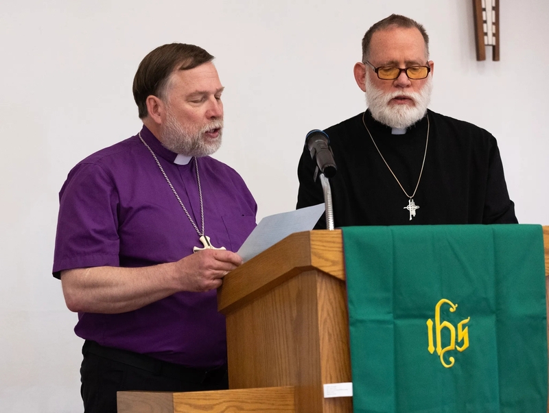 Bishop Timothy R. Oslovich, left, of the Alaska Synod, and Pastor Robert Hattle of Shishmaref Lutheran Church deliver an apology at the memorial service for Tummassak on Oct. 4, 2026. Tummassak died more than 100 years ago while attending the Carlisle Indian Industrial School, and her remains were finally returned to Alaska in October. (Credit: Charles Fox/Special to ICT)