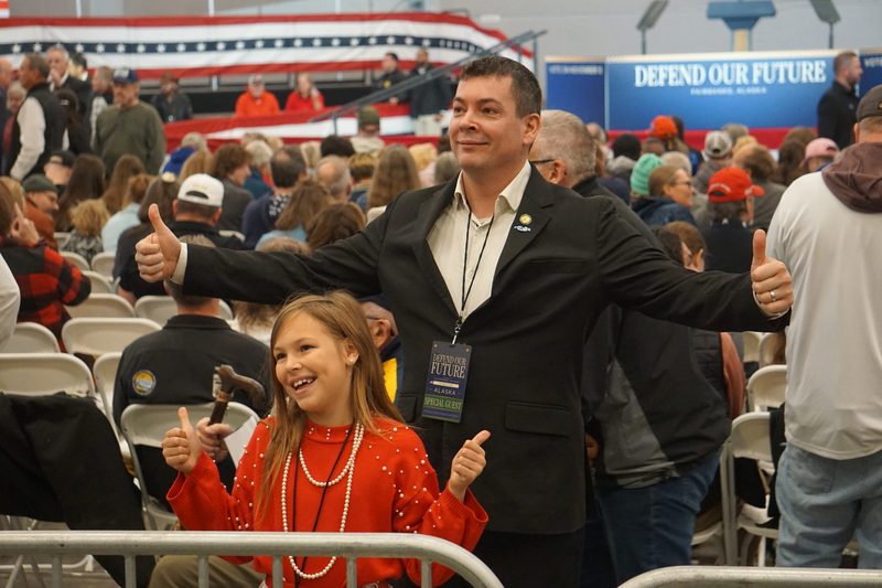 State Rep. Will Stapp, R-Fairbanks, and his 8-year-old daughter Amelia pose for photos at a campaign rally held Oct. 5, 2026, in Fairbanks. The rally was headlined by Vice President JD Vance, who came to Alaska to campaign for U.S. Sen. Dan Sullivan, R-Alaska. Stapp was among several Alaska Republican politicians who gathered hours before Vance's arrival at the venue, an airport hangar. Amelia Stapp later led the crowd in the Pledge of Allegiance. (Photo by Yereth Rosen/Alaska Beacon)