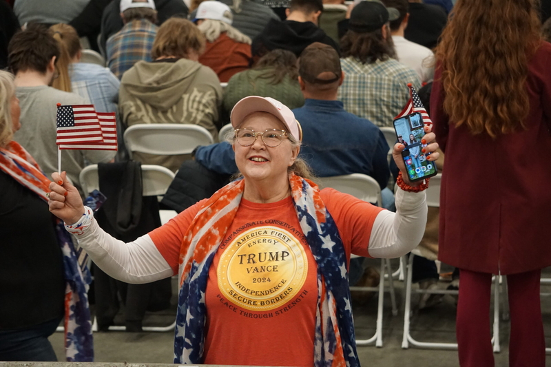 A rally attendees shows off her pro-Trump attire as she waits for the arrival of JD Vance at the Oct. 5, 2026, event in Fairbanks. Vance came to Fairbanks to campaign for U.S. Sen. Dan Sullivan, R-Alaska. (Photo by Yereth Rosen/Alaska Beacon)
