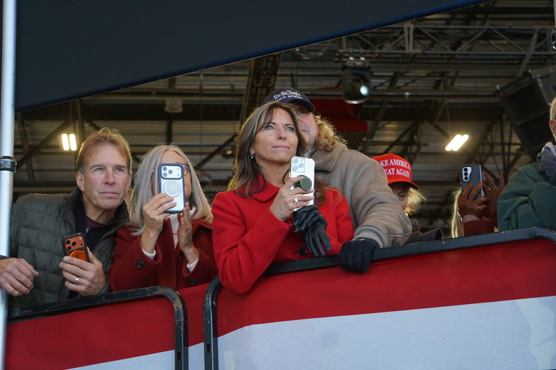 Attendees at an Oct. 5, 2026, campaign rally in Fairbanks use their phones to record the arrival of Air Force 2, which was carrying Vice President JD Vance. Vance came to Alaska to campaign for U.S. Sen. Dan Sullivan, R-Alaska. (Photo by Yereth Rosen/Alaska Beacon)