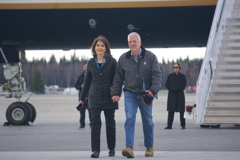 U.S. Sen. Dan Sullivan, R-Alaska, holds hands with his wife, Julie Fate Sullivan, asa they walk from Air Force 2 to a stage set i[ fpr a campaign rally in a Fairbanks hangar on Oct. 5, 2026. Sullivan traveled to Fairbanks with Vice President JD Vance, who was in Alaska campaiging for the senator's reelection. (Photo by Yereth Rosen/Alaska Beacon)