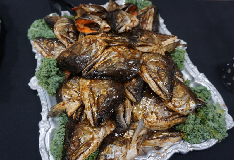 Fish heads are arrayed in a dah at the Indigenous Peoples Day celebration on Oct. 12, 2026, at Alaska Pacific University. Attendees were also served moose stew, another traditional food. (Photo by Yereth Rosen/Alaska Beacon)