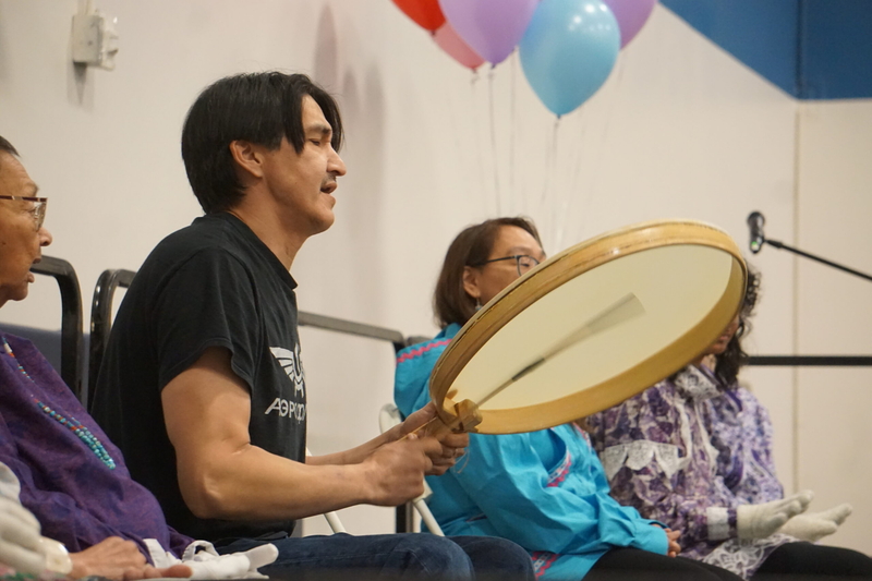 Curtis Silook, a member of with the Sivuqaq Dance Group of Anchorage, plays a drum during a performance at the Indigenous Peoples Day celebration held Oct. 12, 2026, at Alaska Pacific University. The dance group members are from St. Lawrence Island in the Bering Strait region, though residing in Anchorage. (Photo by Yereth Rosen/Alaska Beacon)