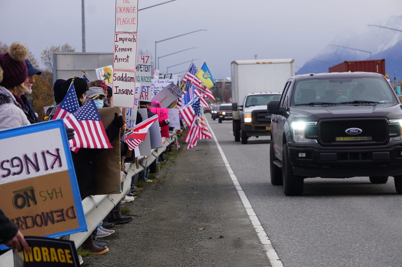 Protestors line the Parks Highway in Wasilla on Oct. 13, 2026, in the afternoon of a campaign rally by President Donald Trump in the city. Trump was in Wasilla to stump for U.S. Sen. Dan Sullivan, R-Alaska. (Photo by Yereth Rosen/Alaska Beacon)