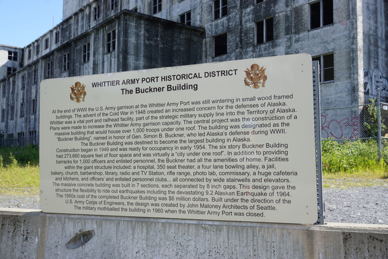A sign, seen Aug. 5, 2024, explains the history of the Buckner Building in Whittier. THe building was erected by the U.S. Army Corps of Engineers but used for only a few years before being abandoned. (Photo by Yereth Rosen/Alaska Beacon)