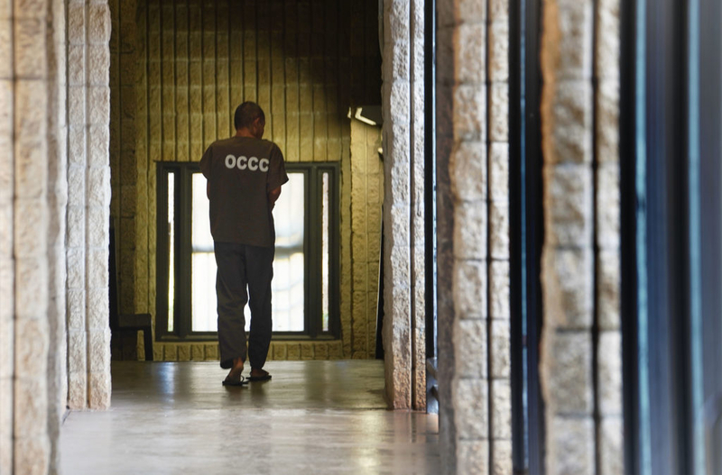 Oahu Community Correctional Center media tour 2019 inmate walks down hall.
