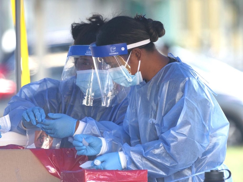 Medical technicians prepare COVID-19 tests, for sending to labs, at the Blaisdell drive-through testing site in Honolulu, Monday, December 27, 2021. (Ronen Zilberman photo Civil Beat)