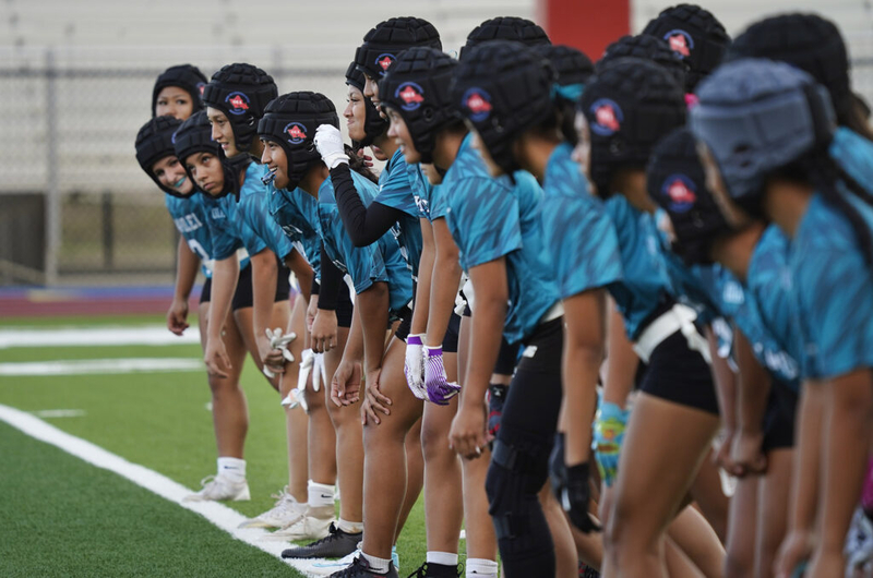 Joyful smiles spread across Kapolei High School girls flag football players faces even for running sprints before taking on Dreamhouse Nā Hōkū in the first Hawai’i girls high school flag football game Tuesday, March 25, 2025, at Wai’anae High School in Wai’anae. (Kevin Fujii/Civil Beat/2025)