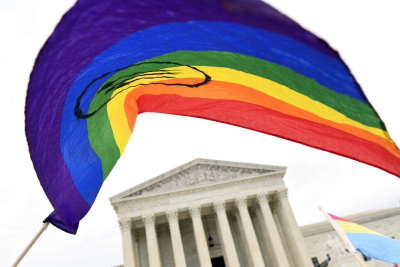 FILE - In this Oct. 8, 2019, file photo, protesters gather outside the Supreme Court in Washington, where the Supreme Court is hearing arguments in the first case of LGBT rights since the retirement of Supreme Court Justice Anthony Kennedy. LGBT-rights activists are looking ahead as they celebrate a major victory in the Supreme Court regarding job discrimination, They hope the June 15, 2020, decision spurs action against other forms of bias against their community and undermines the Trump administration’s