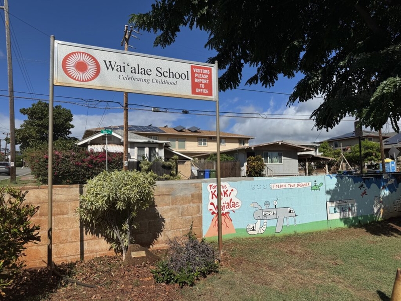 Welcome sign at Waiʻalae School with the name of the school and motto "Celebrating Childhood"